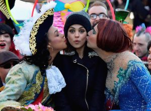 Mila Kunis (C) gets kissed on the cheek at the parade for Hasty Pudding Theatricals' Woman Of The Year on January 25, 2018.