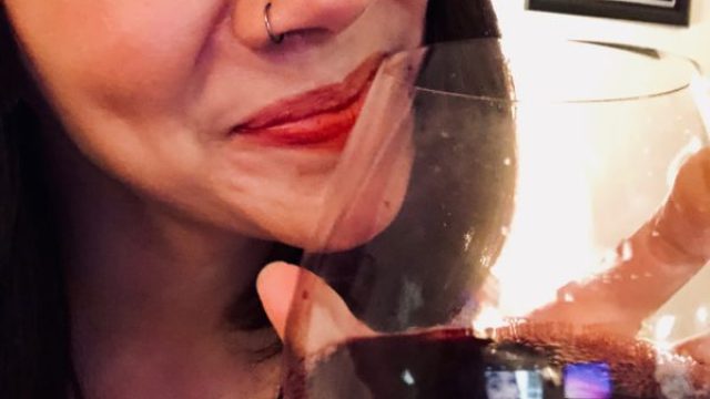 Girl holds wine glass
