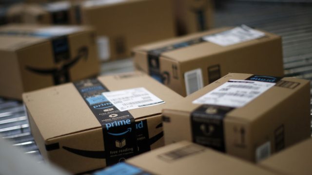 Boxes move along a conveyor belt at the Amazon.com fulfillment center in Kenosha, Wisconsin, U.S., on Tuesday, Aug. 1, 2017. Amazon.com Inc. held a giant job fair at nearly a dozen U.S. warehouses as part of its effort to hire 100,000 people in the U.S. by 2018.