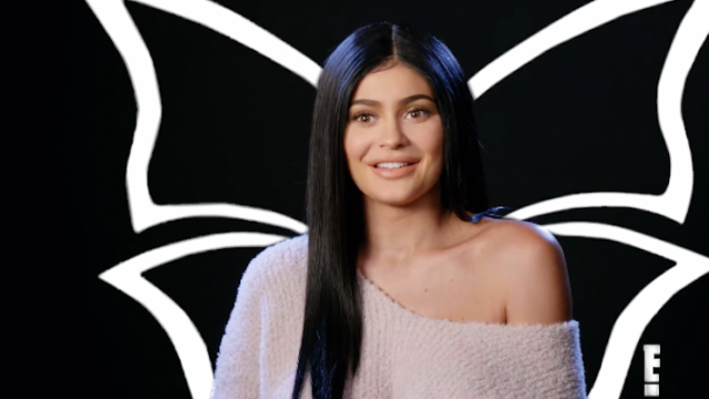 Kylie Jenner with butterfly outline behind her