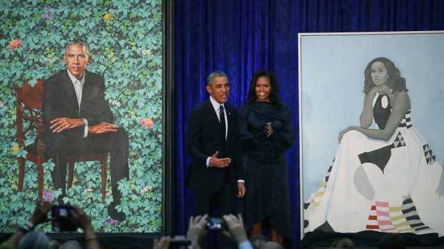 WASHINGTON, DC - FEBRUARY 12: Former U.S. President Barack Obama and former first lady Michelle Obama stand next to their newly unveiled portraits during a ceremony at the Smithsonian's National Portrait Gallery, on February 12, 2018 in Washington, DC. The portraits were commissioned by the Gallery, for Kehinde Wiley to create President Obama's portrait, and Amy Sherald that of Michelle Obama.