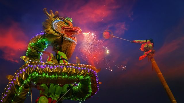 A group of people perform a dragon dance during Chinese new year's celebration in Bangkok, Thailand