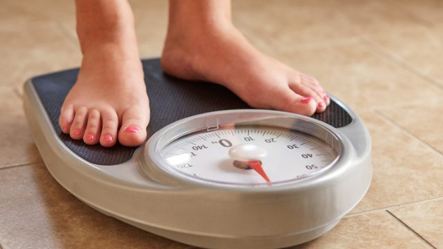 Girl on bathroom scale