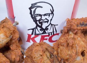 Photo of KFC Logo With a Selection of Chicken Pieces