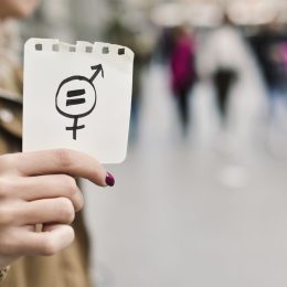 Image of woman holding equality sign