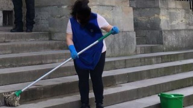 Woman scrubbing "Happy International Women's Day" off steps is going viral.