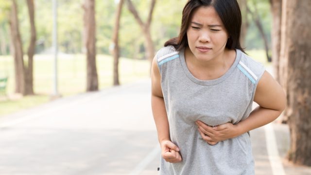 Women chest pain while jogging. Sport injury concept