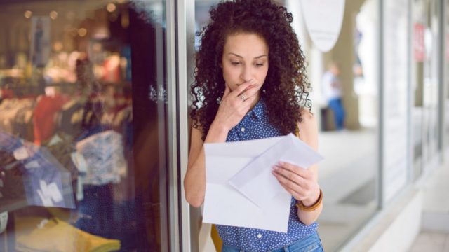 Portrait of a young woman getting the mail