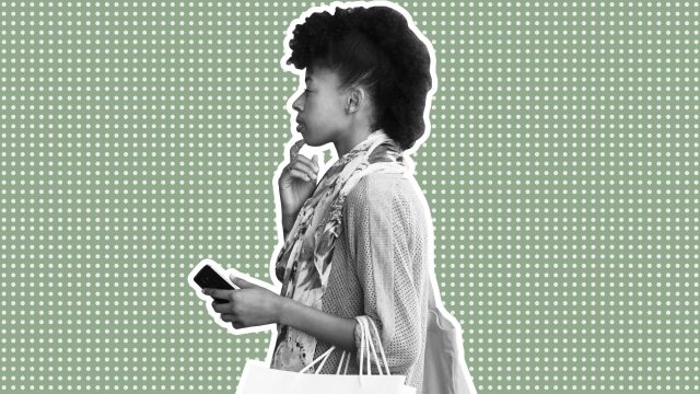 Young woman looking at store window