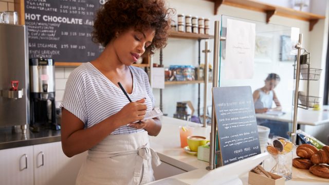 Waitress writing down order