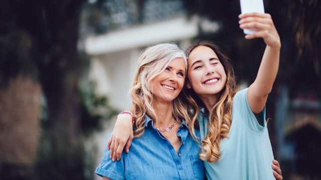 Mom and daughter taking selfie together