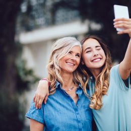 Mom and daughter taking selfie together