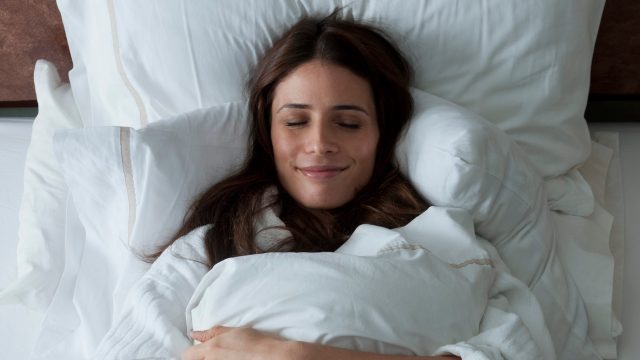 Woman enjoying her comfortable bed
