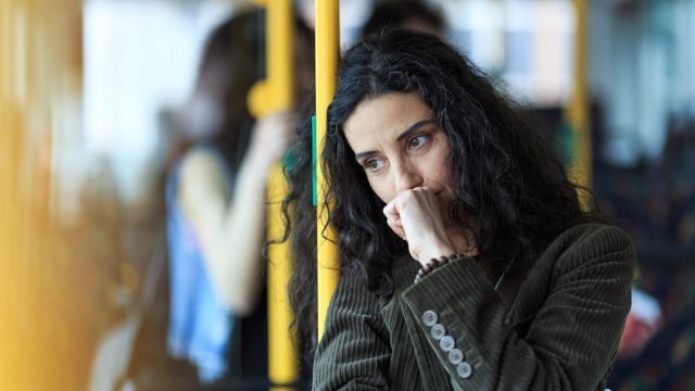Anxious-looking woman traveling on the bus