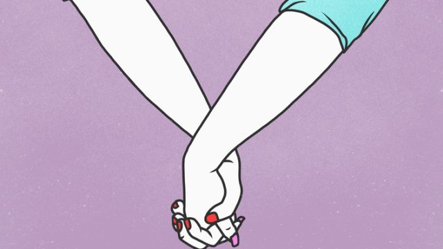 Two women holding hands