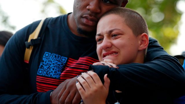 Anti-gun violence advocate and Marjory Stoneman Douglas High School shooting survivor Emma Gonzalez (R) is comforted at the "End of School Year Peace March and Rally" in Chicago, on June 15, 2018. - A boisterous Chicago rally and march kicked off a national gun-reform tour on Friday by students from Parkland, Florida, site of one of the worst US school shootings. The students-turned-activists have become powerful national voices with their "March For Our Lives" campaign pushing for reforms of gun laws, following the February 14 mass shooting at Marjory Stoneman Douglas High School, which killed 17 students and school staff. (Photo by JIM YOUNG / AFP) (Photo credit should read JIM YOUNG/AFP/Getty Images)