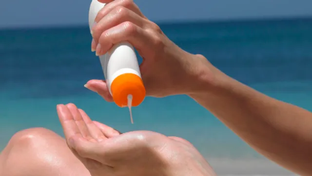Image of woman applying sunscreen