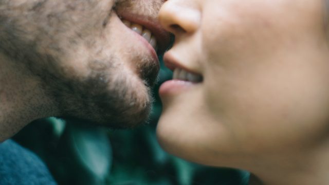 Closeup of a man and woman's mouths about to kiss