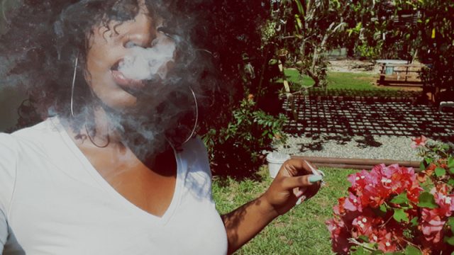 Young Black woman smoking marijuana