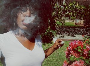 Young Black woman smoking marijuana