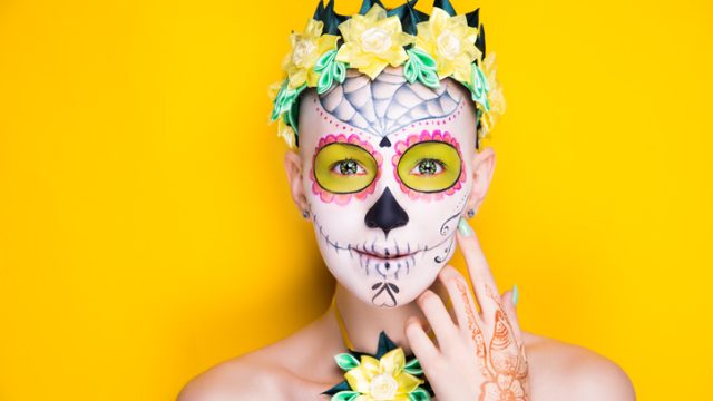 Woman wearing sugar skull makeup for Dia De Los Muertos
