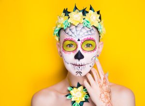 Woman wearing sugar skull makeup for Dia De Los Muertos