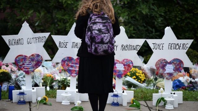 Woman standing at memorial outside Pittsburgh synagogue shooting