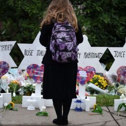 Woman standing at memorial outside Pittsburgh synagogue shooting