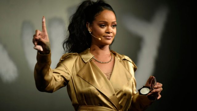 DUBAI, UNITED ARAB EMIRATES - SEPTEMBER 29: Rihanna gestures on stage during her Fenty Beauty talk in collaboration with Sephora, for the launch of her new Stunna Lip paint "Uninvited" on September 29, 2018 in Dubai, United Arab Emirates.