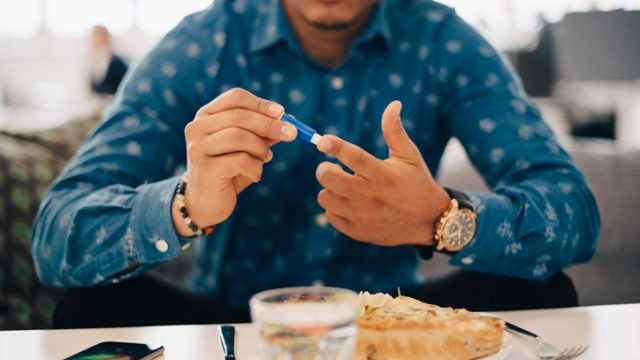 Diabetic man taking blood test