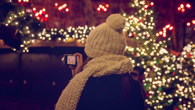 Woman in front of Christmas lights