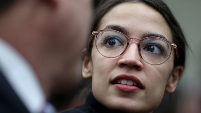 WASHINGTON, DC - NOVEMBER 30: Rep.-elect Alexandria Ocasio-Cortez (D-NY) speaks with a colleague at the lottery draw for congressional offices November 30, 2018 in Washington, DC. As part of the new member orientation process, newly elected members of the U.S. House of Representatives take part in drawing random numbers that provide the order for selecting available congressional office space.