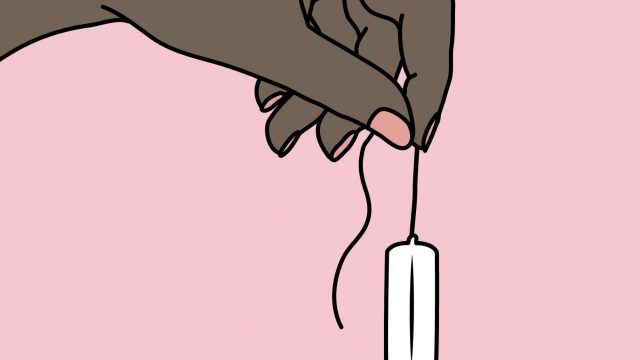 Hand holding a new tampon