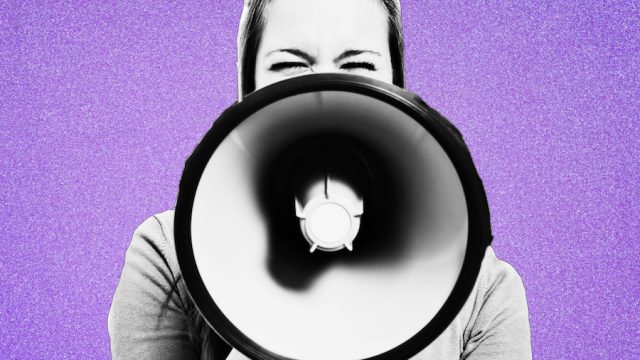 Woman holding megaphone on purple bakground