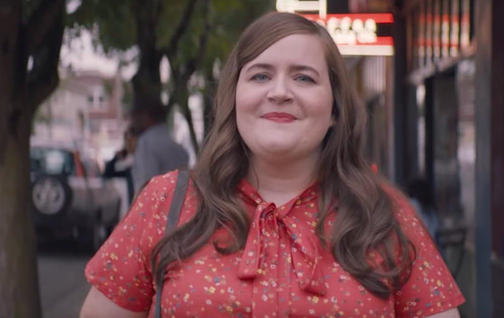 shrill woman in red jumpsuit