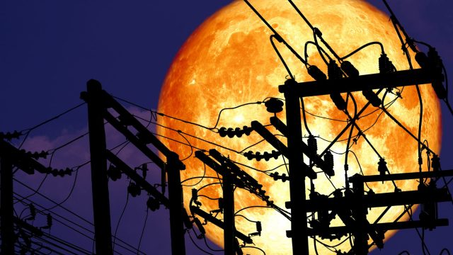 full moon behind telephone wires