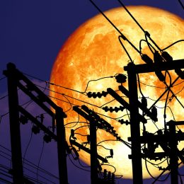 full moon behind telephone wires