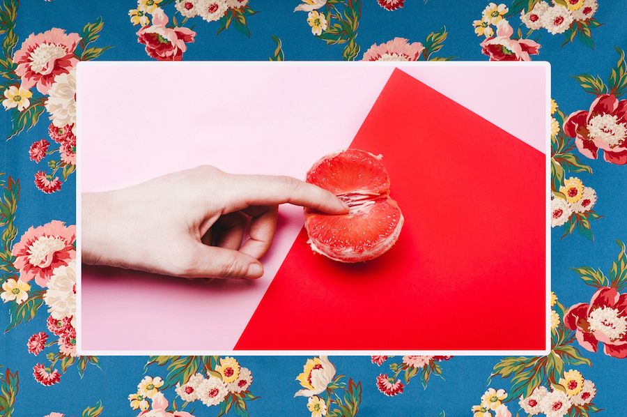 Collage of a finger touching orange sections on a floral background