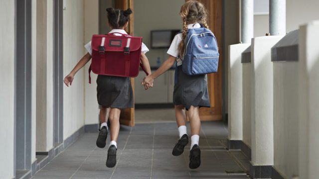 School girls wearing skirts.