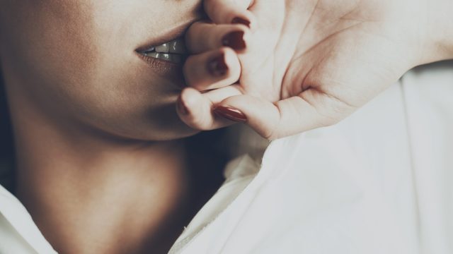Seductive woman hand on her face