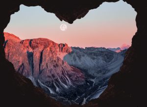 full moon framed by heart-shaped cave