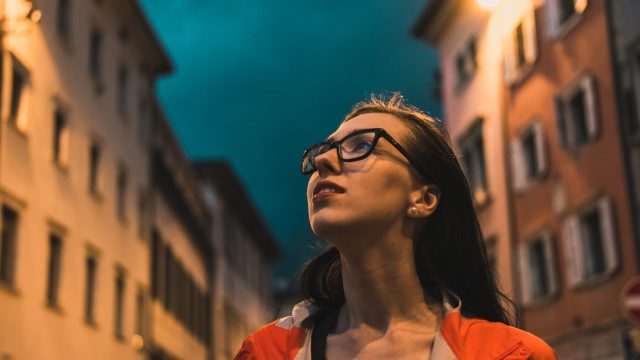 young woman looking at night sky