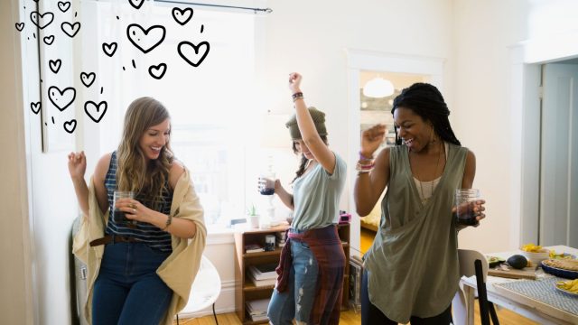 three women friends dancing at home