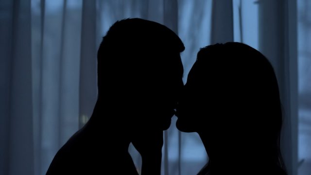 couple kissing in the dark