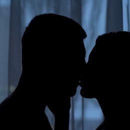 couple kissing in the dark