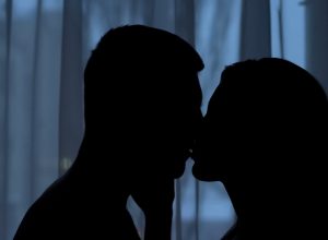 couple kissing in the dark