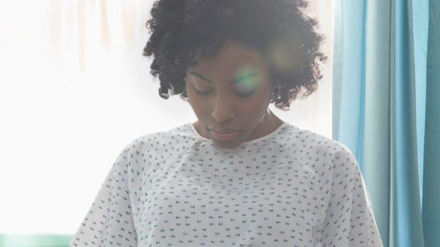 Black woman in hospital gown