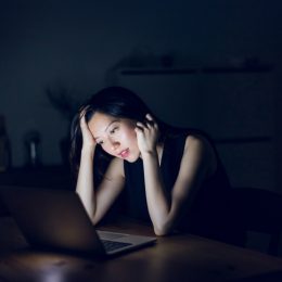Stressed woman looking at laptop