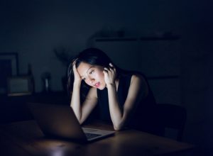 Stressed woman looking at laptop