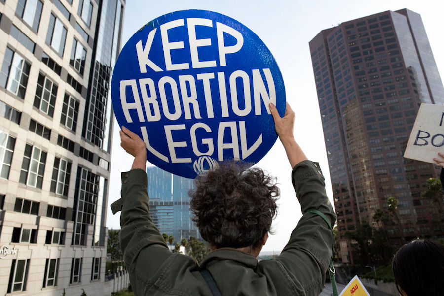 Protester holding "Keep Abortion Legal" sign at ban protest in Los Angeles